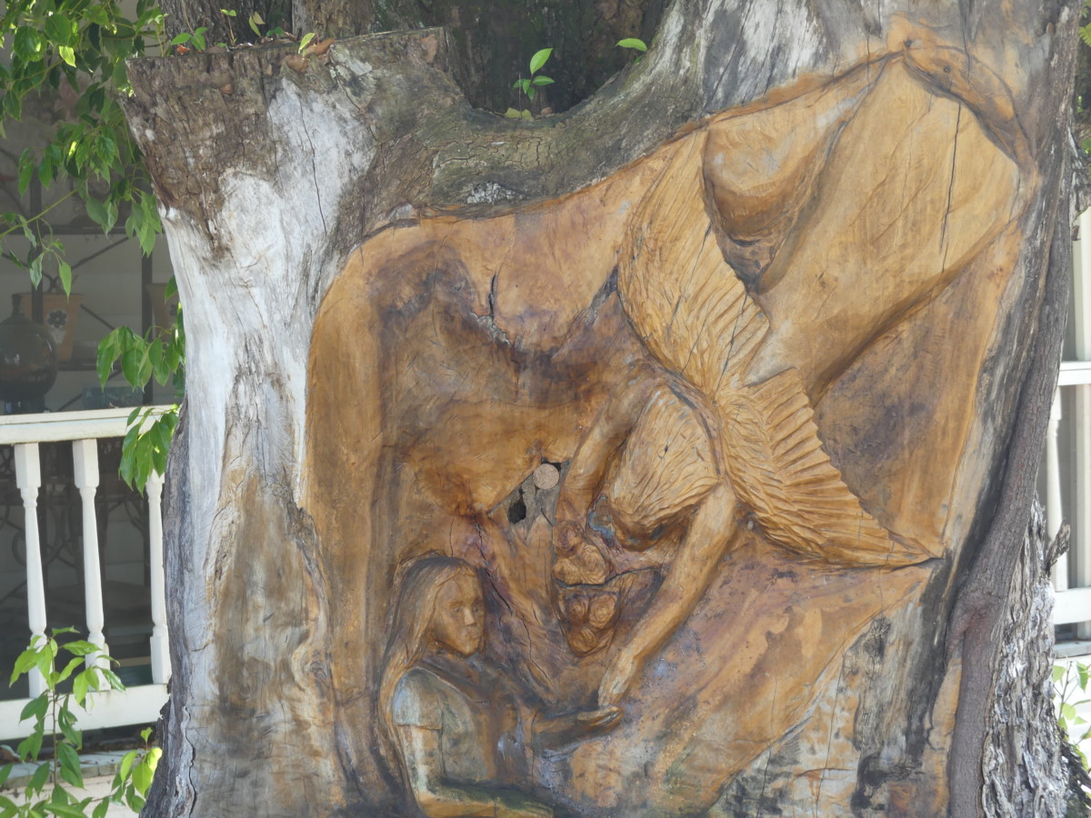 Carving of girl in tree