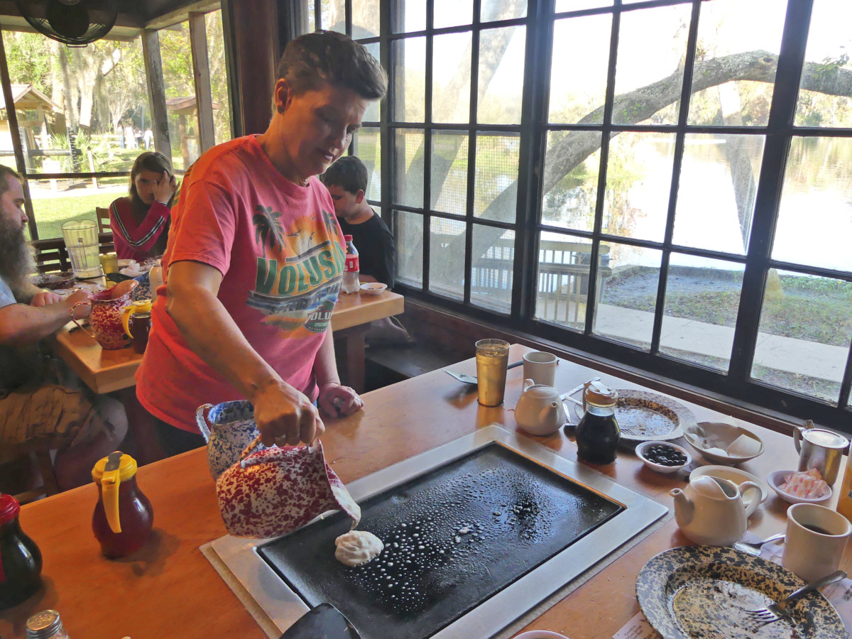 Pouring pancakes at Sugar Mill Restaurant in DeLeon Spring State Park