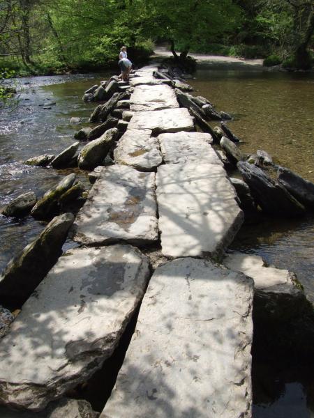 The clapper bridge has been rebuilt using the same stone many times due to flood waters washing it away.