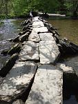 The clapper bridge has been rebuilt using the same stone many times due to flood waters washing it away.