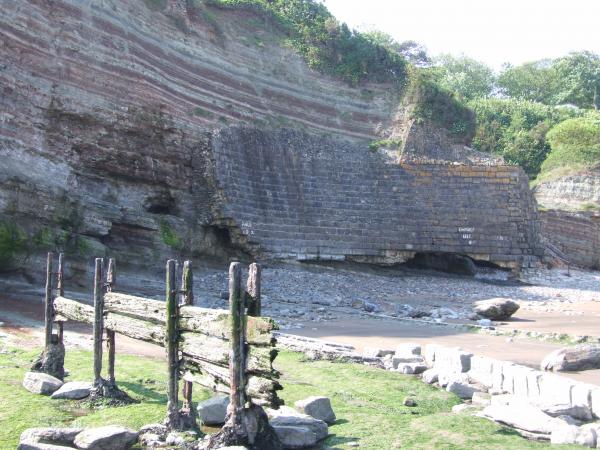 What remains of the harbour wall. There used to be a big slipway to the beach where horse and carts used to haul deliverys of coal from Wales up to the top. Now you can just see the steps that have been put in to get access to the bay. The rest has eroded away.