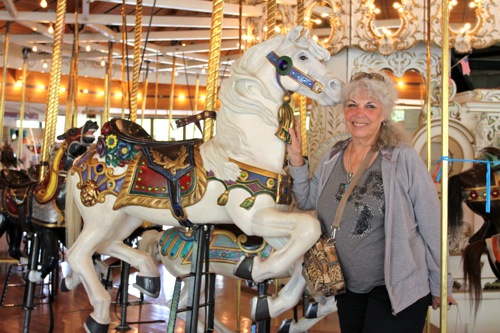 Mom poses with a horse carousel built in 1909 in Spokane, WA