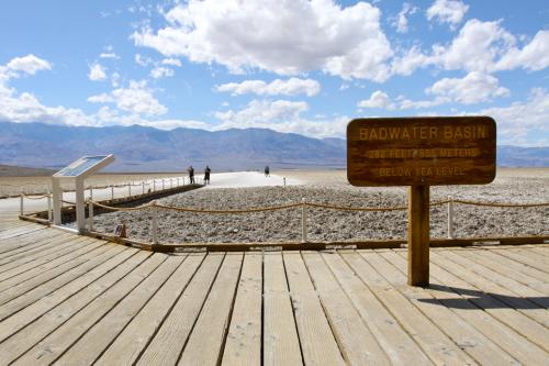 Visitors who decide to walk out to the sands beyond the Badwater Basin sign will find the Salt Flats, crusted hexagonal patterns left behind in Death Valley National Park.