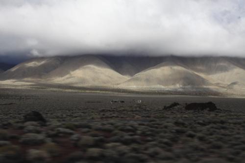 Low remnants of storm clouds cling to the foothills of the Sierras off Hwy 395.