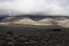 Low remnants of storm clouds cling to the foothills of the Sierras off Hwy 395.