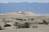 In the distance, Mesquite Sand Dunes can be found in Death Valley NP. You can also hike to the top of them if you're feeling adventurous.