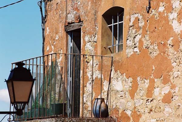 Peeling paint on a balcony wall in Roussillon