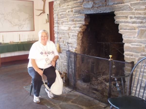 Betty Taking a Break by the Fireplace