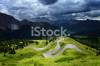 stock-photo-21470728-winding-road-through-the-fields-of-dolomites-alps-valley.jpg