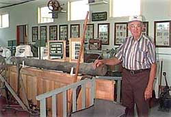 Ray Streblow with the original Oshkosh gas main made of a hollowed-out log
